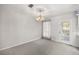 Bright dining room with light carpeting, chandelier, and access to a patio at 7601 Se 22Nd Ave, Ocala, FL 34480