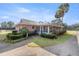 Home with screened porch and mature landscaping at 7601 Se 22Nd Ave, Ocala, FL 34480