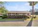 Pink stucco home with a screened porch and lush landscaping at 7601 Se 22Nd Ave, Ocala, FL 34480