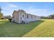 Rear exterior of house with grassy yard at 7601 Se 22Nd Ave, Ocala, FL 34480