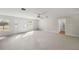 Sunlit living room with carpet, a ceiling fan, and backyard access at 7601 Se 22Nd Ave, Ocala, FL 34480