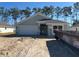 Newly built house featuring a gray exterior, two-car garage, and a well-manicured lawn at 7658 Sw 180Th Cir, Dunnellon, FL 34432