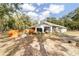 Expansive backyard featuring a charming white home with a screened porch and a wooden fence, perfect for outdoor living at 7670 Se 110Th Street Rd, Belleview, FL 34420