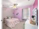 Charming bedroom with a pink color scheme, ceiling fan, and comfortable furnishings at 7670 Se 110Th Street Rd, Belleview, FL 34420