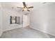 Neutral bedroom featuring soft carpet, a ceiling fan, and convenient access to the en-suite bathroom at 7670 Se 110Th Street Rd, Belleview, FL 34420