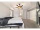 Spacious bedroom with tray ceiling, ceiling fan, and ensuite bathroom access at 7670 Se 110Th Street Rd, Belleview, FL 34420