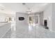 Open living space with white tile flooring, fireplace, and sliding glass doors to the outdoor area at 7670 Se 110Th Street Rd, Belleview, FL 34420