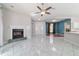 Bright living room with a fireplace, tile flooring, and views of the front entrance and another living area at 7670 Se 110Th Street Rd, Belleview, FL 34420