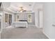 Spacious main bedroom with a tray ceiling, ceiling fan, and sliding doors to the patio at 7670 Se 110Th Street Rd, Belleview, FL 34420