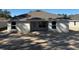 Rear view of a one-story home featuring a neutral color and a covered patio at 7673 Sw 180Th Cir, Dunnellon, FL 34432