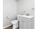 A light gray bathroom featuring a white toilet and sink with gray cabinets at 7688 Se 135Th St, Summerfield, FL 34491