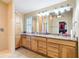 Light and bright bathroom features a granite countertop with double sinks, vanity, and shuttered window at 7688 Se 135Th St, Summerfield, FL 34491