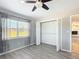 Bedroom showcasing wood-look floors and an open closet with shelving at 7688 Se 135Th St, Summerfield, FL 34491