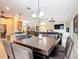 Open-concept dining room with travertine floors that flows into the kitchen and living room at 7688 Se 135Th St, Summerfield, FL 34491