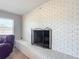 Cozy living room featuring a white brick fireplace with a decorative metal screen at 7688 Se 135Th St, Summerfield, FL 34491