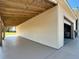 Wide shot of a garage with a covered porch and a beige exterior at 7688 Se 135Th St, Summerfield, FL 34491