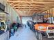 The inside of a garage with equipment, an ATV, and a wooden rafter at 7688 Se 135Th St, Summerfield, FL 34491