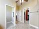 Hallway connects the bathroom and walk-in closet with tile floors and neutral paint at 7688 Se 135Th St, Summerfield, FL 34491