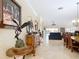 Spacious hallway showcases a decorative display cabinet with tile floors leading to the living area at 7688 Se 135Th St, Summerfield, FL 34491