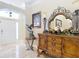 Elegant hallway with a view of the front door and living area enhanced by a decorative console at 7688 Se 135Th St, Summerfield, FL 34491