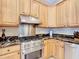 Close up of the kitchen featuring stainless steel appliances, oak cabinets, and granite countertops at 7688 Se 135Th St, Summerfield, FL 34491