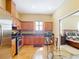 Kitchen adjacent to bedroom with stainless steel appliances and custom cabinets at 7688 Se 135Th St, Summerfield, FL 34491