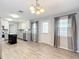 Well-lit dining area with a stylish chandelier, leading into a modern kitchen at 7688 Se 135Th St, Summerfield, FL 34491