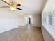 Spacious living room featuring wood-look flooring, lots of natural light, and neutral paint at 7688 Se 135Th St, Summerfield, FL 34491