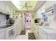 Galley kitchen with white appliances and laundry at 8240 Sw 107Th Ln, Ocala, FL 34481