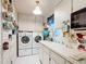 Bright laundry room with washer, dryer, and ample storage at 8240 Sw 107Th Ln, Ocala, FL 34481