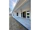 Covered back patio featuring a ceiling fan, concrete flooring and sliding glass doors at 8481 Sw 137 Ct, Dunnellon, FL 34432