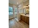 Beautiful bathroom featuring a glass shower, wood-style flooring, and a granite countertop sink at 8481 Sw 137 Ct, Dunnellon, FL 34432