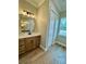 Bathroom with wood-style flooring, white countertops, a large vanity, and a window at 8481 Sw 137 Ct, Dunnellon, FL 34432