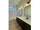 Bathroom featuring a double vanity, soaking tub, and modern fixtures at 8481 Sw 137 Ct, Dunnellon, FL 34432