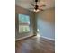 Bedroom with hard wood floors, neutral paint, a ceiling fan, and a window at 8481 Sw 137 Ct, Dunnellon, FL 34432