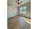 Sun-filled bedroom with wood-style floors, a ceiling fan, and a large window at 8481 Sw 137 Ct, Dunnellon, FL 34432