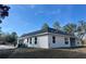 Side view of a home with a dark roof and light colored exterior paint at 8481 Sw 137 Ct, Dunnellon, FL 34432