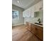 Functional laundry room featuring wood cabinets, granite countertops, and a sink, offering convenience and style at 8481 Sw 137 Ct, Dunnellon, FL 34432