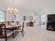 Open-concept dining area featuring a wood table with seating for six and wood flooring at 8510 Sw 108Th Place Rd, Ocala, FL 34481