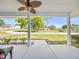 Inviting front porch view with fan, neutral flooring, and green scenery at 8510 Sw 108Th Place Rd, Ocala, FL 34481