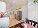 Well-lit kitchen featuring white cabinets, stainless steel appliances, light countertops and modern flooring at 8510 Sw 108Th Place Rd, Ocala, FL 34481