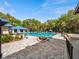 Large community pool area with shaded seating, manicured landscape, and blue pavilion at 8510 Sw 108Th Place Rd, Ocala, FL 34481