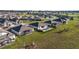 Aerial view showcasing homes with screened patios and backyard pools in a vibrant neighborhood at 8630 Sw 61St Loop, Ocala, FL 34481