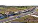 An elevated view of a street of suburban homes near green spaces, and a golf course at 8630 Sw 61St Loop, Ocala, FL 34481