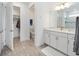 Bright bathroom offers a closet and a sleek vanity, complemented by neutral tiling at 8630 Sw 61St Loop, Ocala, FL 34481