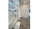 Bright bathroom featuring white tile, a glass door, and tile floors at 8630 Sw 61St Loop, Ocala, FL 34481