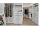 Well-organized walk-in closet offers ample storage with shelves, drawers, and hanging rods for clothes and accessories at 8630 Sw 61St Loop, Ocala, FL 34481