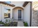 Inviting front entrance with stone accents and a dark blue door with sidelight window at 8630 Sw 61St Loop, Ocala, FL 34481