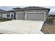 Two car garage featuring modern doors and a concrete driveway at 8630 Sw 61St Loop, Ocala, FL 34481