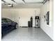 Garage interior with epoxy floor and a Tesla car at 8630 Sw 61St Loop, Ocala, FL 34481